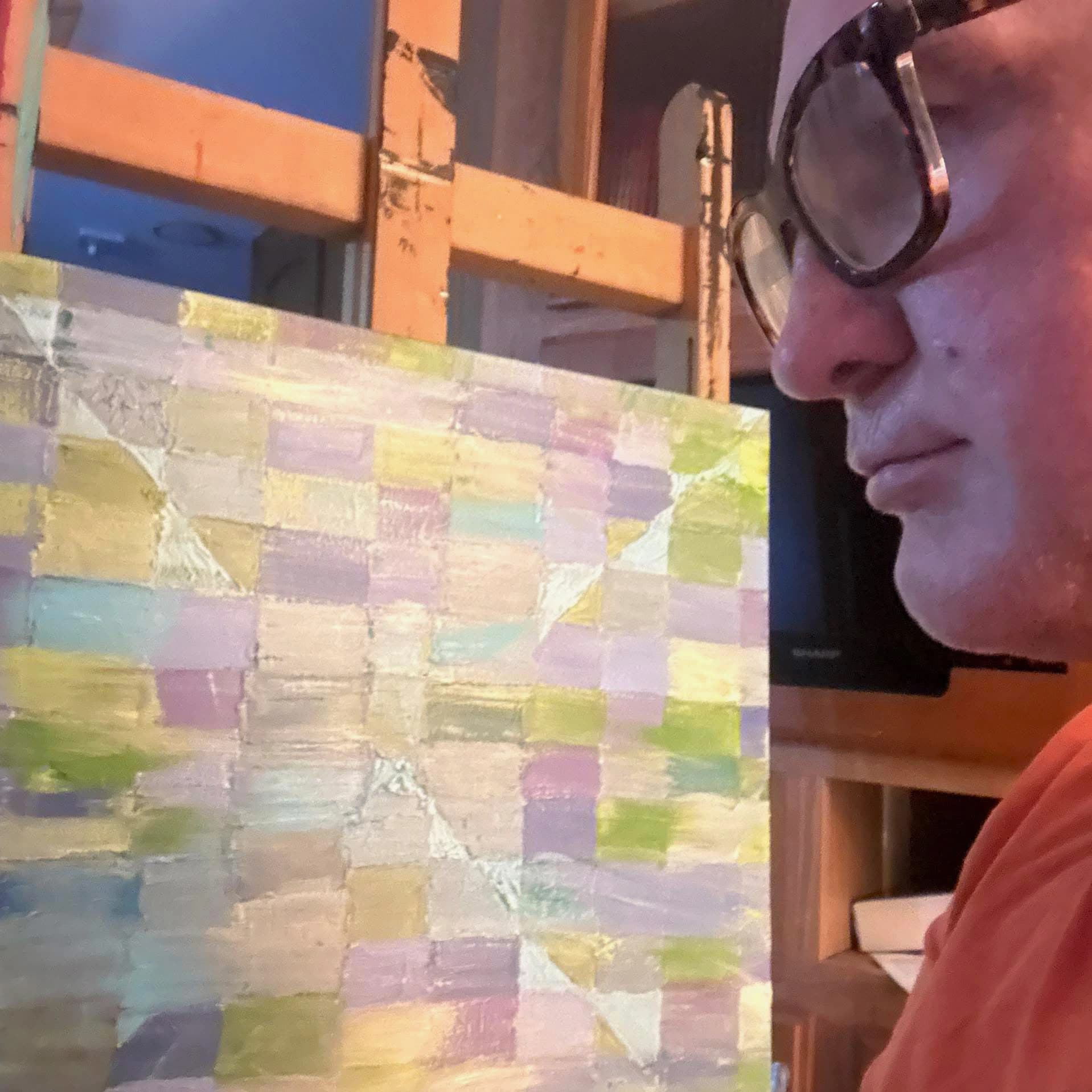 Darrin Cathorall Embrey beside a painting.